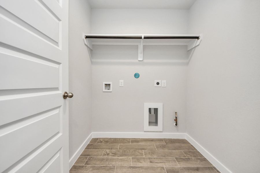 A perfect blend of functionality and comfort. Capture the essence of easy living with a first-floor laundry room, thoughtfully equipped with shelving for effortless organization. Both electric and gas connections available. Sample photo of completed home with similar floor plan. Actual colors and selections may vary. A perfect blend of functionality and comfort. Capture the essence of easy living with a first-floor laundry room, thoughtfully equipped with shelving for effortless organization. Both electric and gas connections available. Sample photo of completed home with similar floor plan. Actual colors and selections may vary.