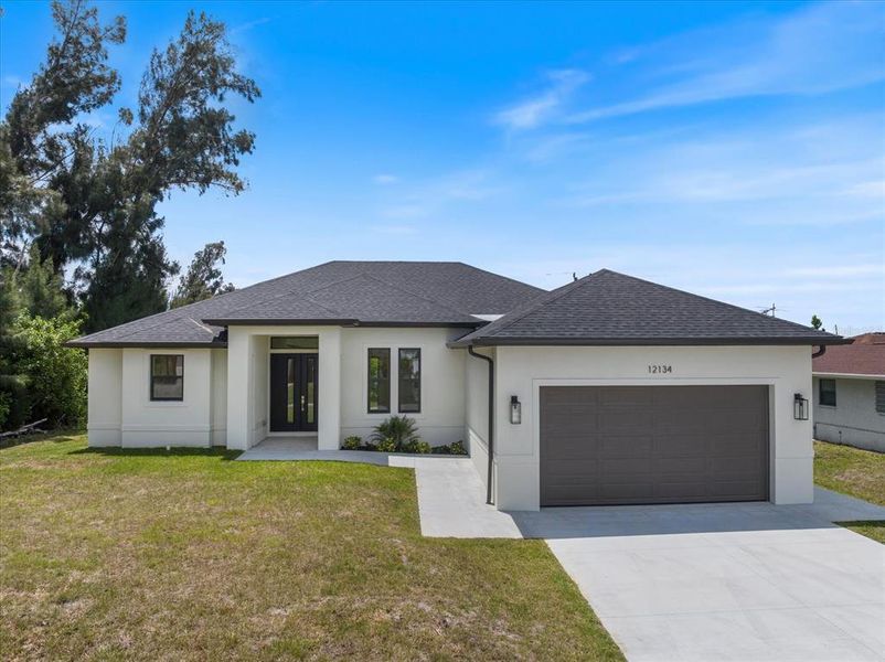 Front exterior of a new home in , North Port, FL, highlighting curb appeal (Image 1). Front exterior of a new home in , North Port, FL, highlighting curb appeal (Image 1).