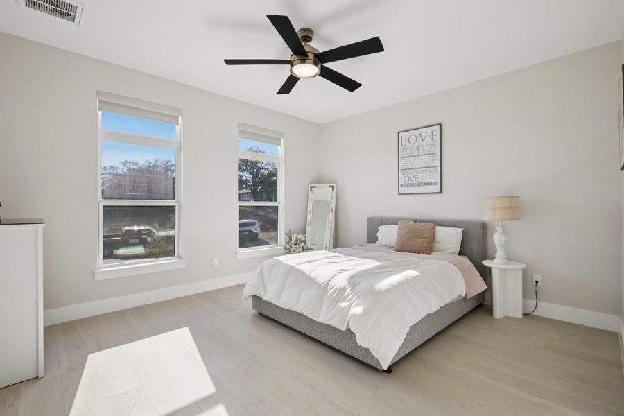 Bedroom with light wood-style floors and a ceiling fan