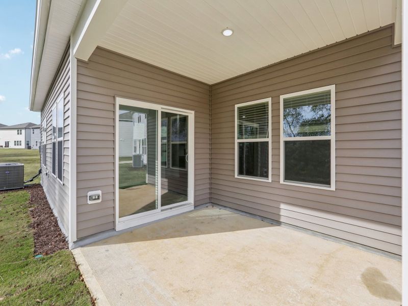 Covered rear patio of the Chandler floorplan at a Meritage Homes community in Angier, NC.