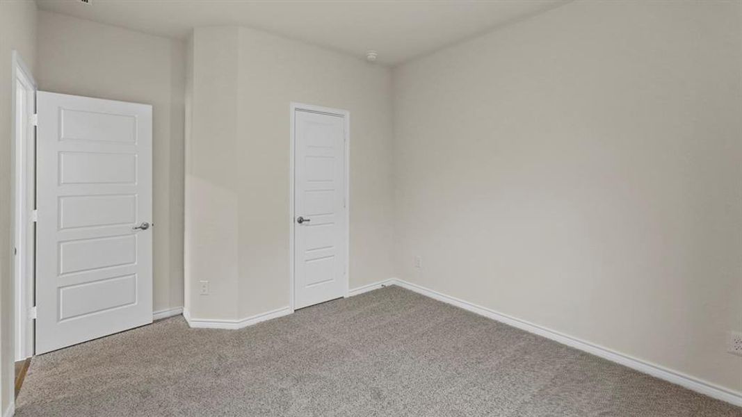 Light gray textured carpeting with white baseboards