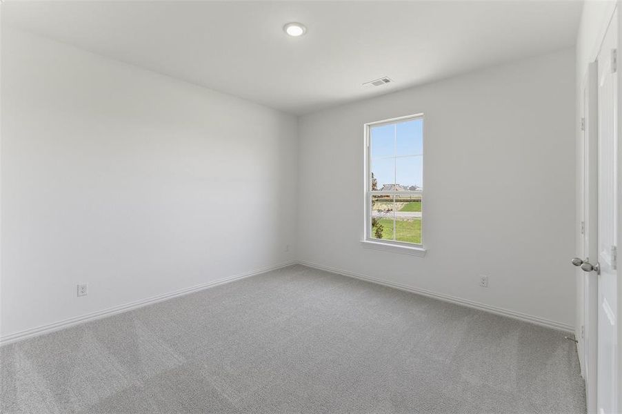 Bright interior room with plush grey carpeting and white walls