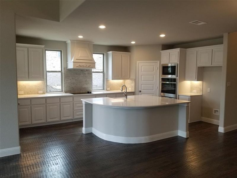 Gourmet kitchen has windows, large island, and would be perfect for entertaining.