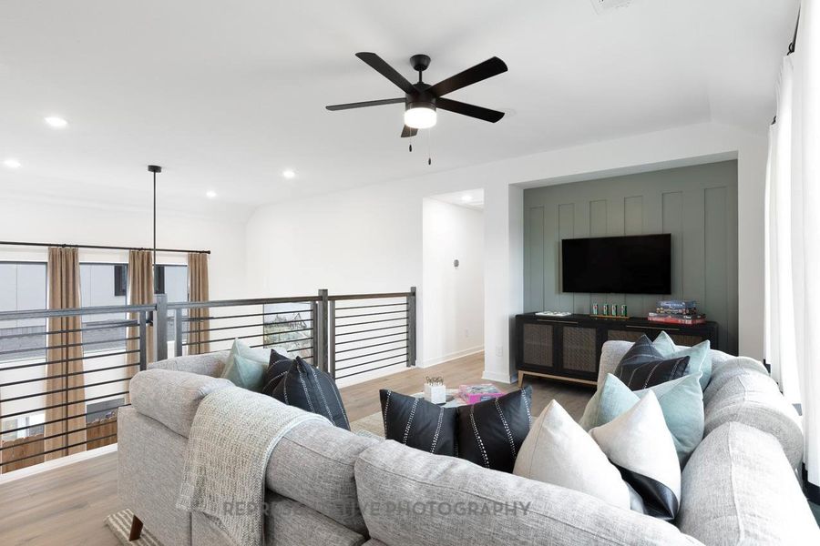 Living room featuring wood finished floors, ceiling fan, and recessed lighting Living room featuring wood finished floors, ceiling fan, and recessed lighting