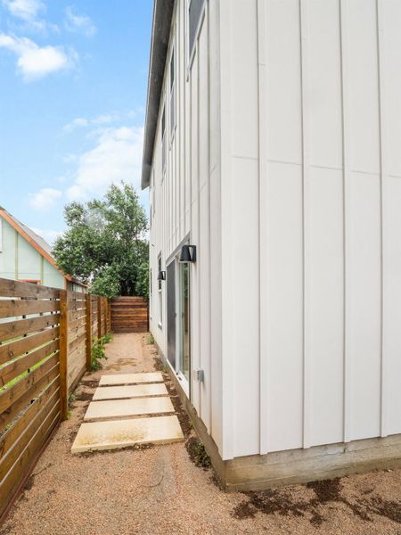 Modern vertical panel siding with exterior sconce lighting