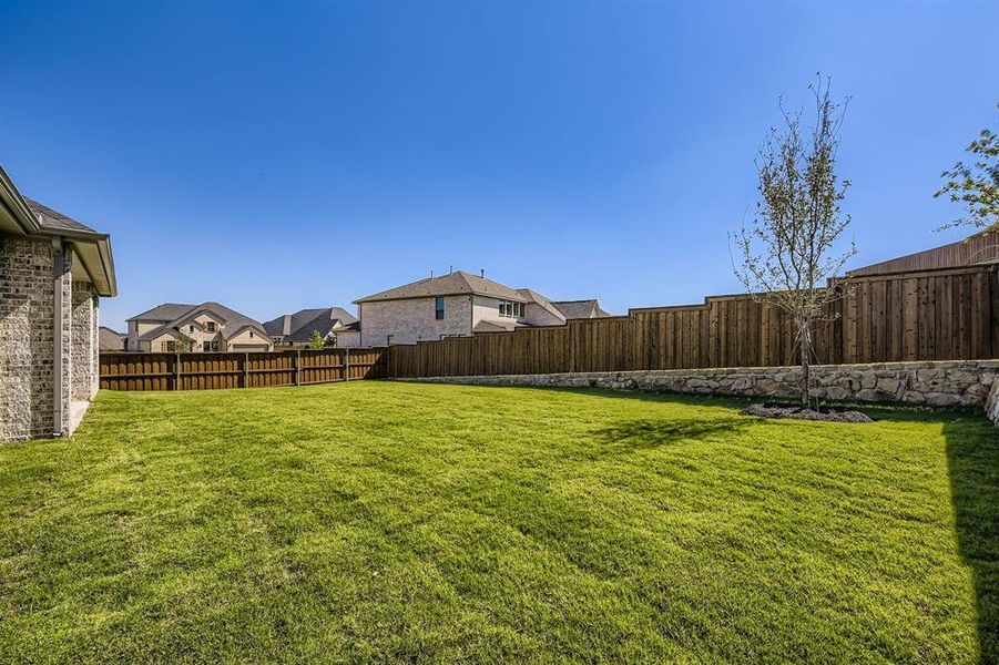 Fenced backyard featuring a residential view Fenced backyard featuring a residential view