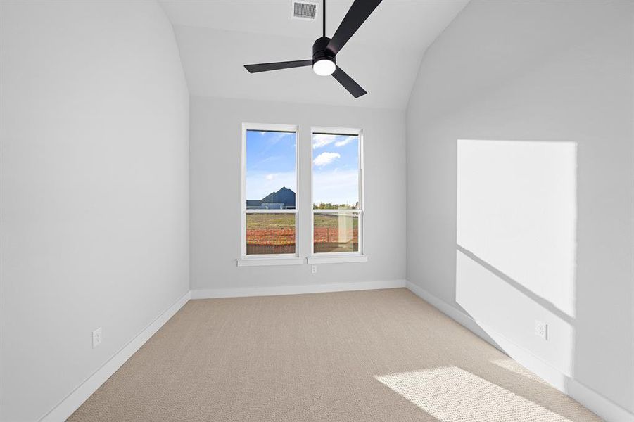 Spare room with light carpet, lofted ceiling, and ceiling fan Spare room with light carpet, lofted ceiling, and ceiling fan