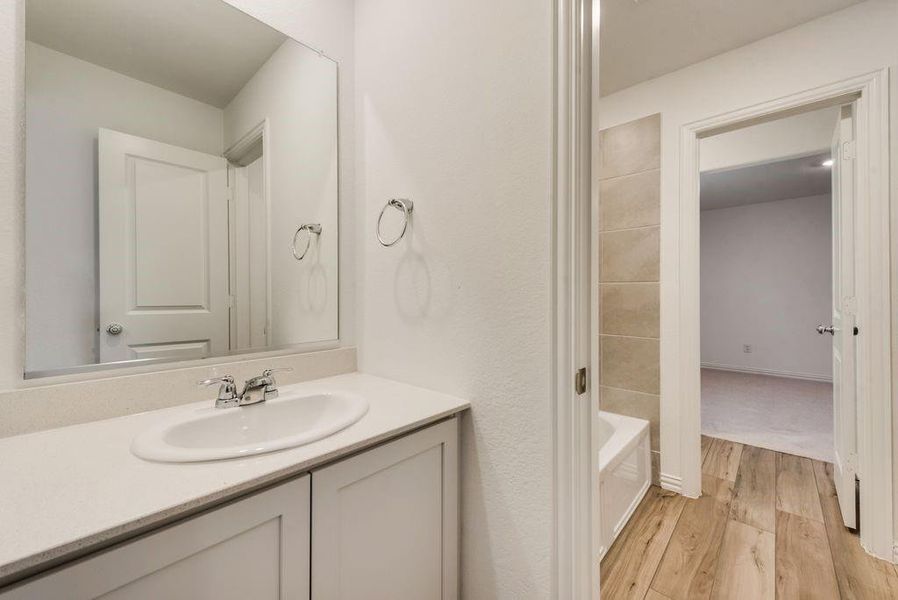 Bathroom featuring vanity and hardwood / wood-style floors