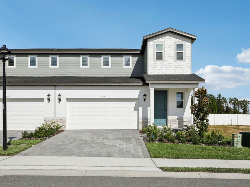 Front exterior of a new home in Cyrene at Minneola - Villas, Minneola, FL, highlighting curb appeal (Image 1). Front exterior of a new home in Cyrene at Minneola - Villas, Minneola, FL, highlighting curb appeal (Image 1).