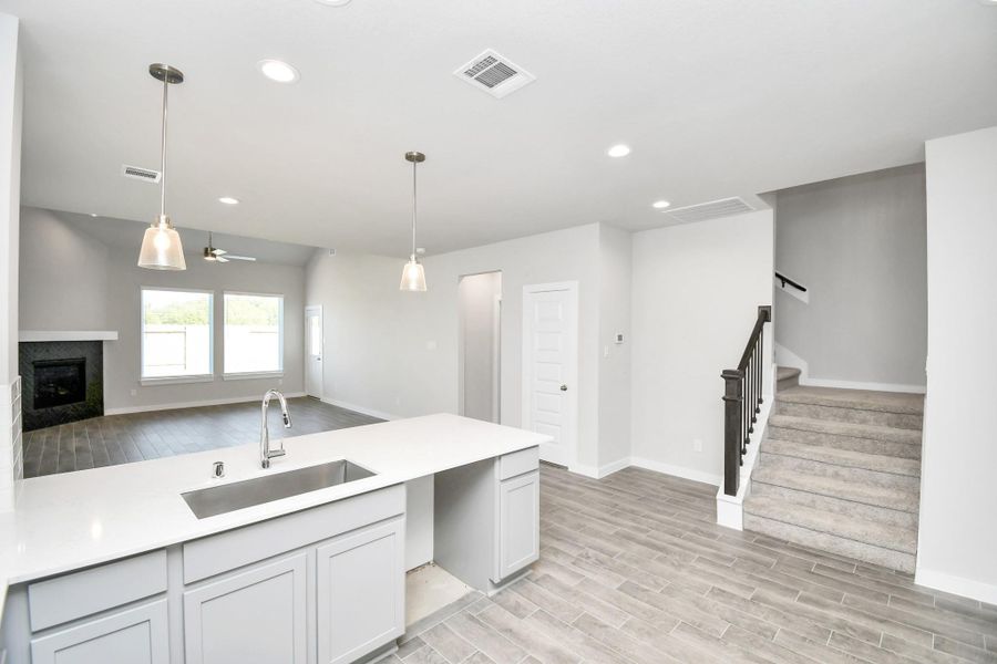 This kitchen is truly a chef's dream! This haven Boasts high ceilings, recessed & pendant lighting, stained wood cabinets, granite countertops, stainless steel appliances, a modern tile backsplash. All of this overlooks your expansive family room, creating a perfect space for culinary delights and family gatherings. This kitchen is truly a chef's dream! This haven Boasts high ceilings, recessed & pendant lighting, stained wood cabinets, granite countertops, stainless steel appliances, a modern tile backsplash. All of this overlooks your expansive family room, creating a perfect space for culinary delights and family gatherings.