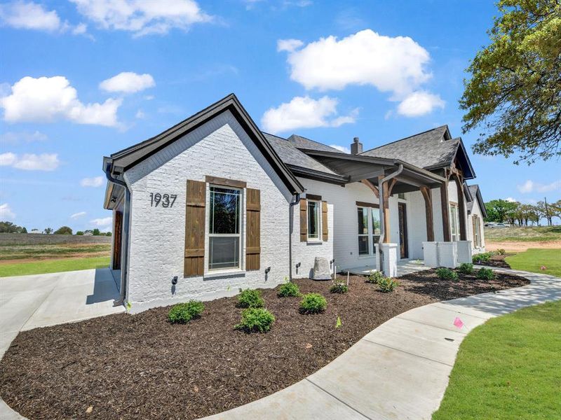 View of home's exterior featuring a chimney View of home's exterior featuring a chimney