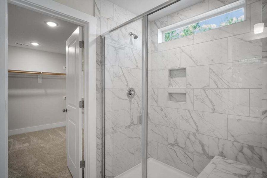 Owners Suite Bathroom with Tile Walls and Bench