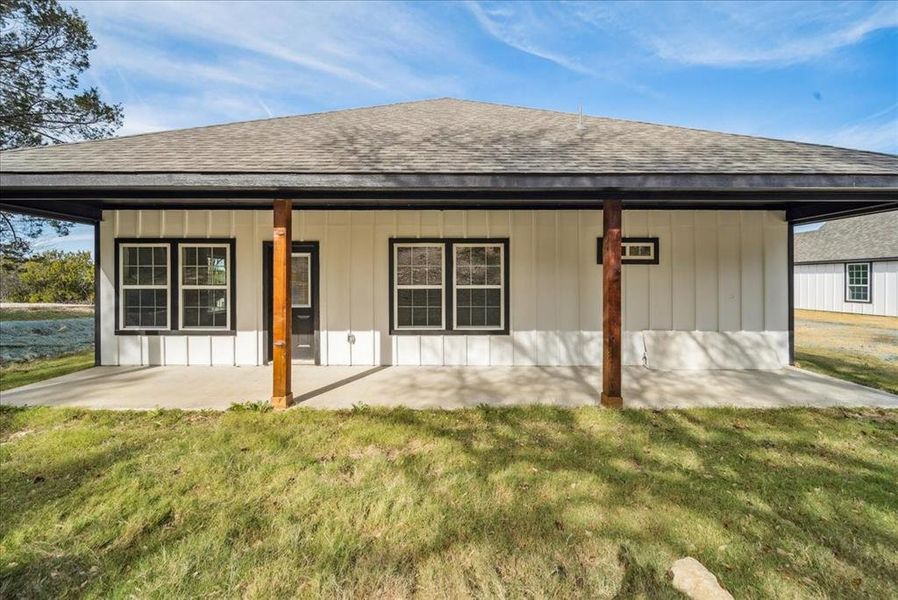 Rear view of property with a porch and a yard