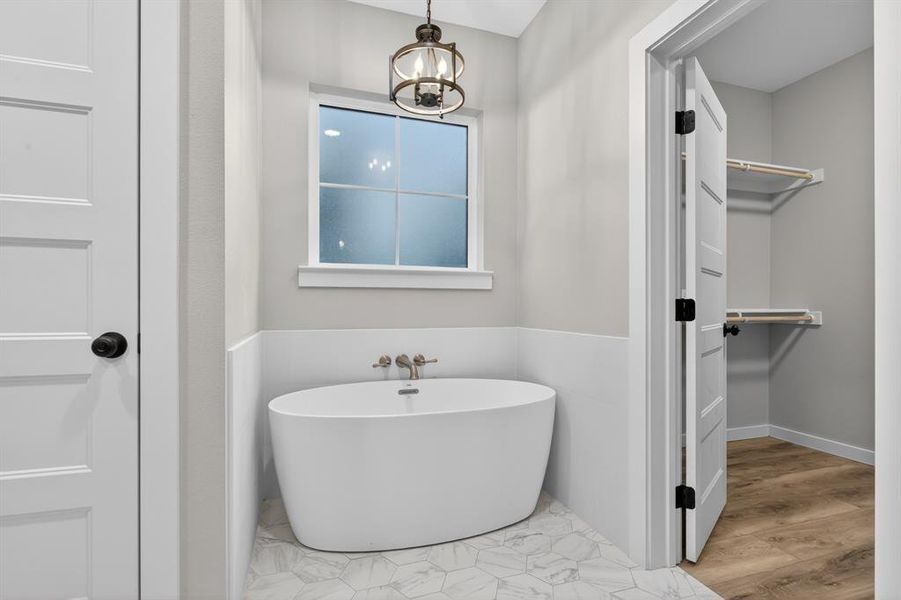 Enjoy soaking in the tub after a long day of work! Primary bathroom opens to primary walk-in closet.