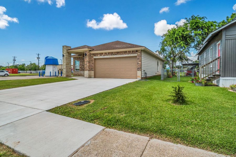 Front exterior of a new home in , Freeport, TX, highlighting curb appeal (Image 13).