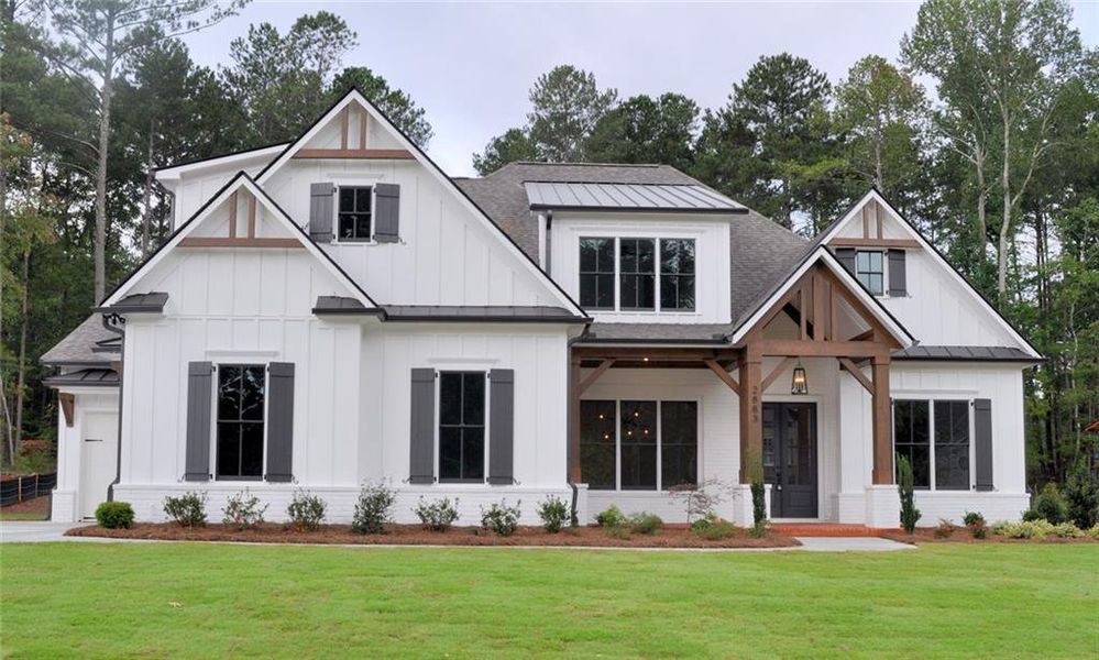 Front exterior of a new home in Malone's Pond, Ball Ground, GA, highlighting curb appeal (Image 1). Front exterior of a new home in Malone's Pond, Ball Ground, GA, highlighting curb appeal (Image 1).