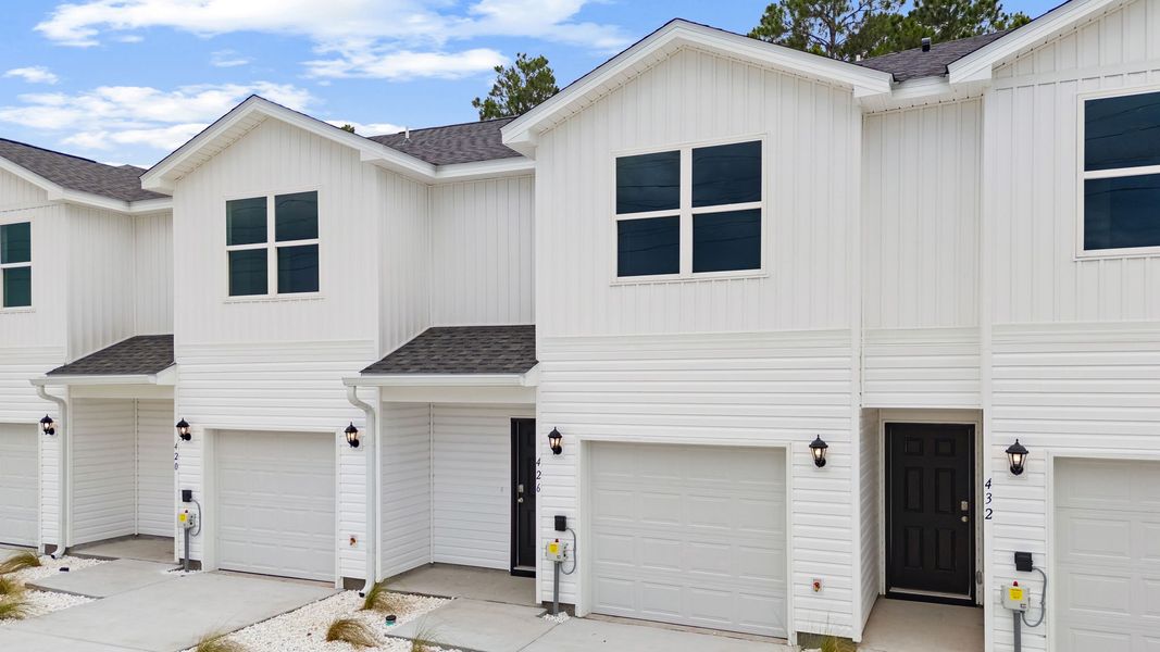 Front exterior of a new home in Chateau Nemours, Port Saint Joe, FL, highlighting curb appeal (Image 2). Front exterior of a new home in Chateau Nemours, Port Saint Joe, FL, highlighting curb appeal (Image 2).