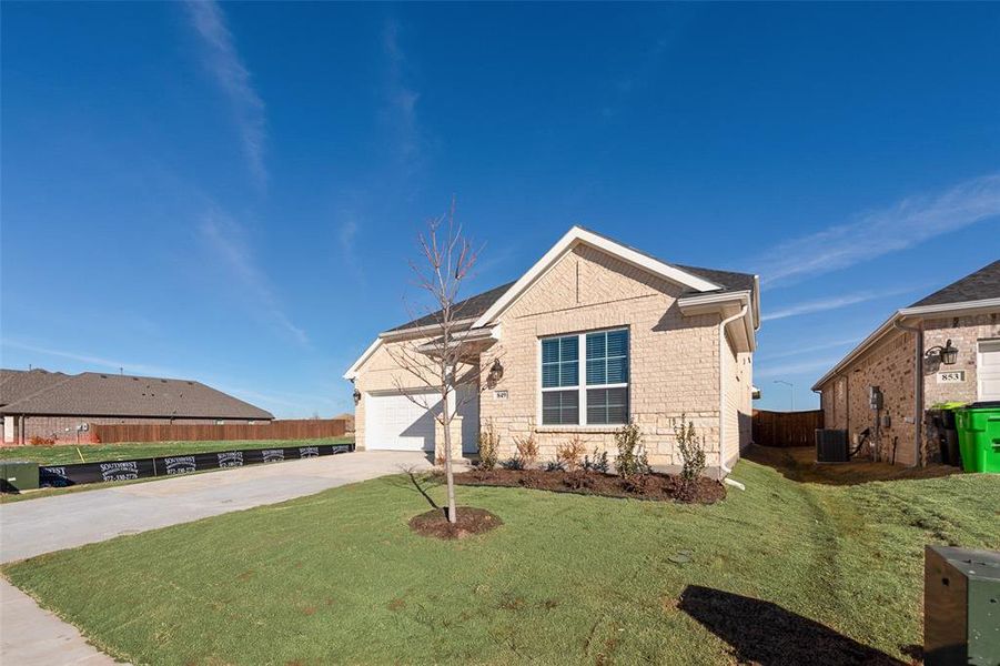 Front exterior of a new home in Wildflower Ranch, Justin, TX, highlighting curb appeal (Image 18).