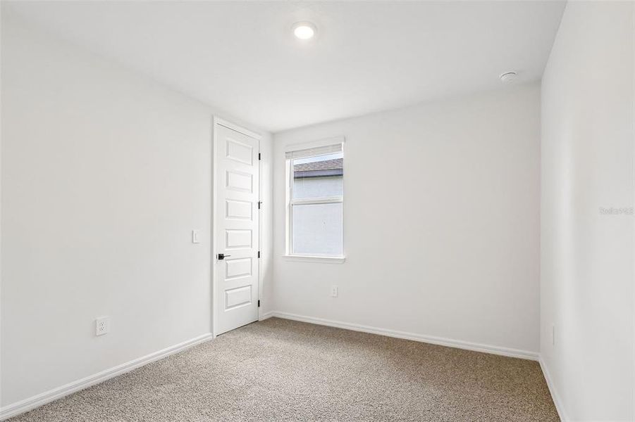 Spacious, unfurnished interior of a new home in The Grove at Stuart Crossing - Signature Series, Bartow (Image 12).