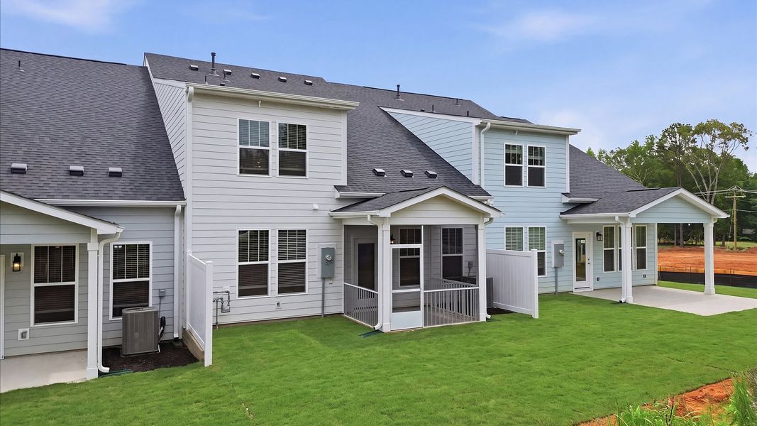 Established charm meets functional outdoor living with a spacious rear covered porch at the Village at Midway community Established charm meets functional outdoor living with a spacious rear covered porch at the Village at Midway community