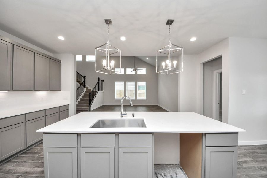 This kitchen is truly a chef's dream! This haven Boasts high ceilings, recessed & pendant lighting, stained wood cabinets, granite countertops, stainless steel appliances, a modern tile backsplash. All of this overlooks your expansive family room, creating a perfect space for culinary delights and family gatherings. This kitchen is truly a chef's dream! This haven Boasts high ceilings, recessed & pendant lighting, stained wood cabinets, granite countertops, stainless steel appliances, a modern tile backsplash. All of this overlooks your expansive family room, creating a perfect space for culinary delights and family gatherings.