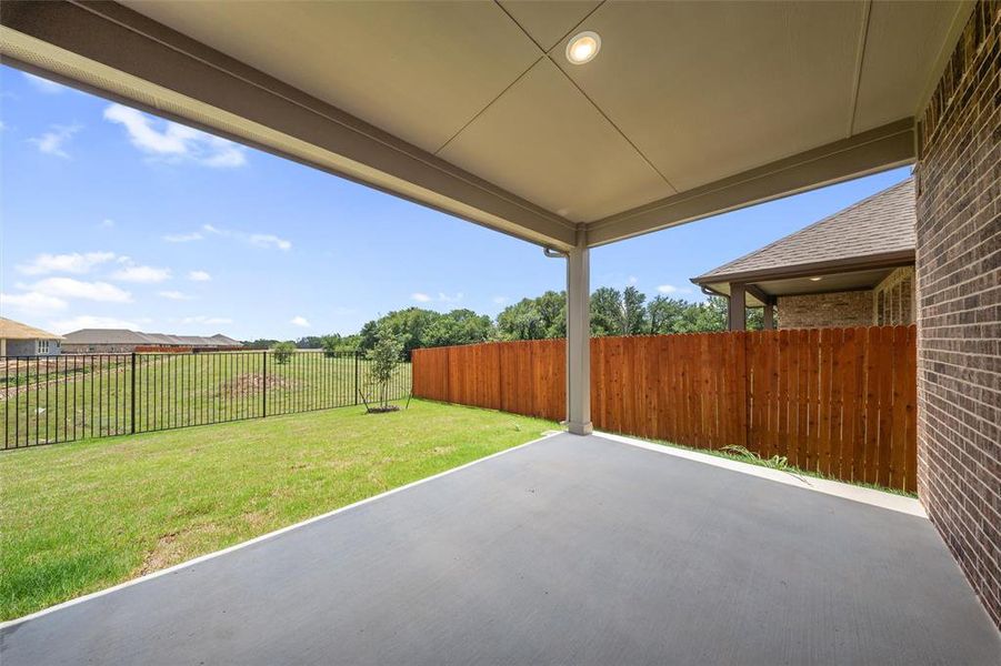 Fenced backyard with a patio area