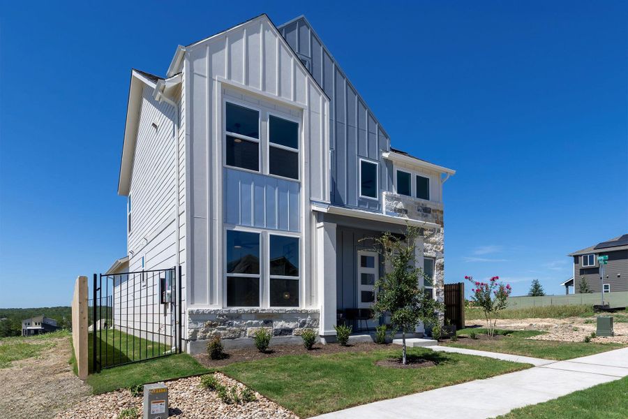 Front exterior of a new home in Whisper Valley, Manor, TX, highlighting curb appeal (Image 26). Front exterior of a new home in Whisper Valley, Manor, TX, highlighting curb appeal (Image 26).