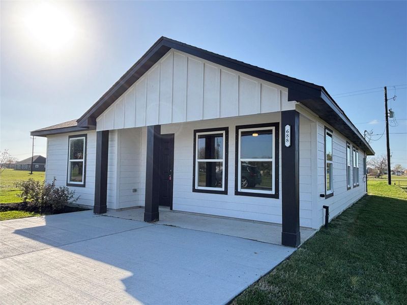 Front exterior of a new home in , Palacios, TX, highlighting curb appeal (Image 17). Front exterior of a new home in , Palacios, TX, highlighting curb appeal (Image 17).