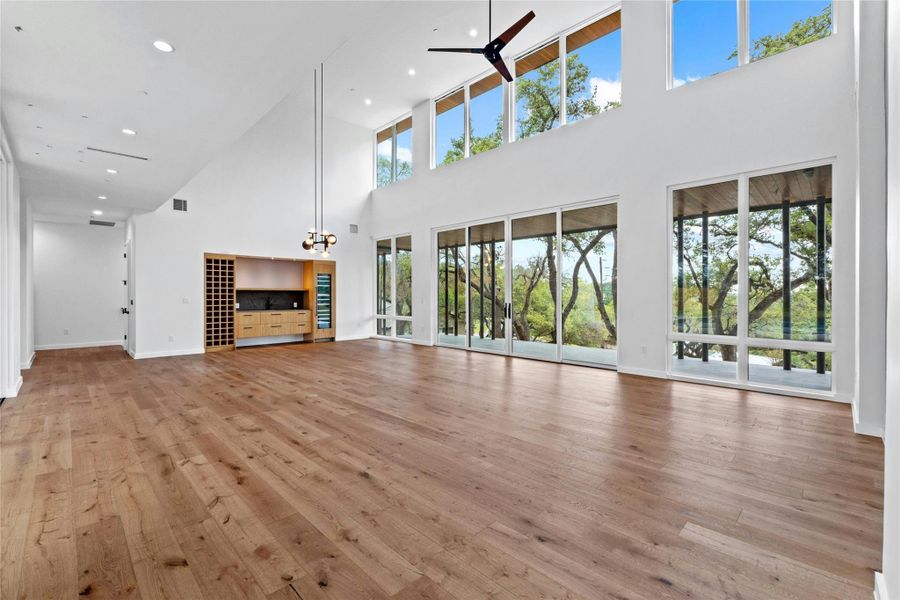 Great room is an expansive living/dining combination. 33'4"x23'5". Double level of windows showcase the room in natural light. Here is where the blue sky meets the sentinel oaks.