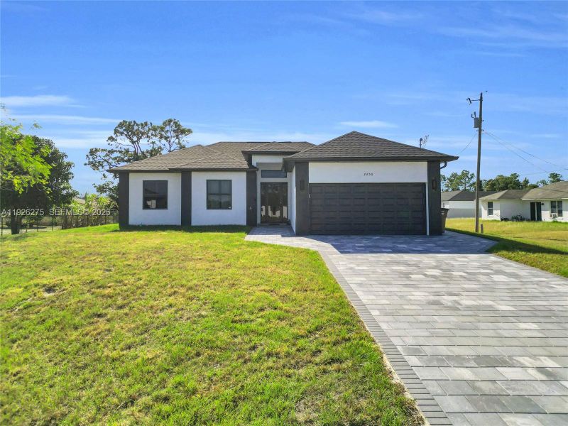 Front exterior of a new home in , Lehigh Acres, FL, highlighting curb appeal (Image 21).