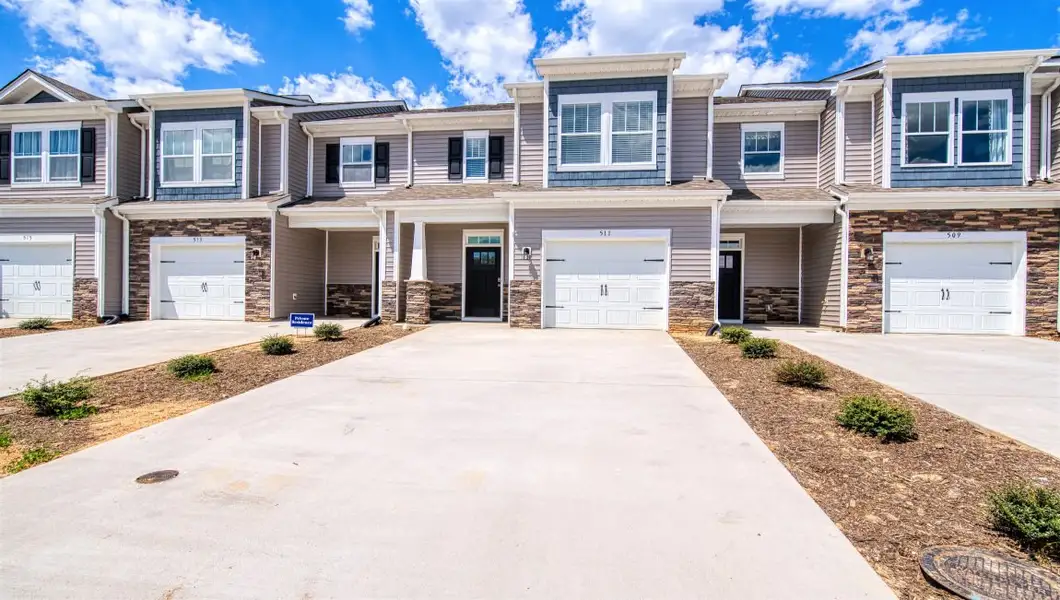 Front exterior of a new home in Townes at Tap Root Farms, Fletcher, NC, highlighting curb appeal (Image 1). Front exterior of a new home in Townes at Tap Root Farms, Fletcher, NC, highlighting curb appeal (Image 1).