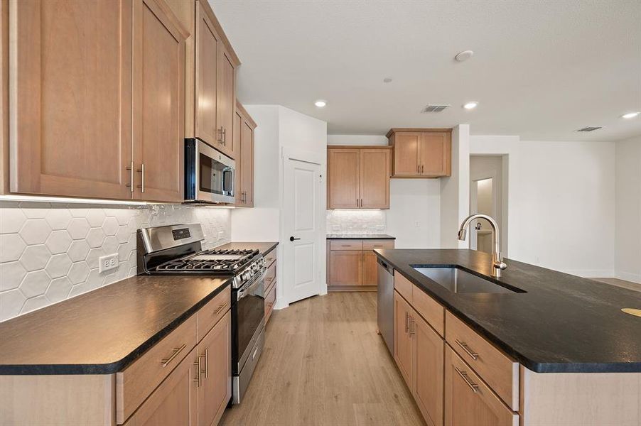 Featuring stainless appliances and thoughtful design elements, this kitchen is one for the books! Featuring stainless appliances and thoughtful design elements, this kitchen is one for the books!