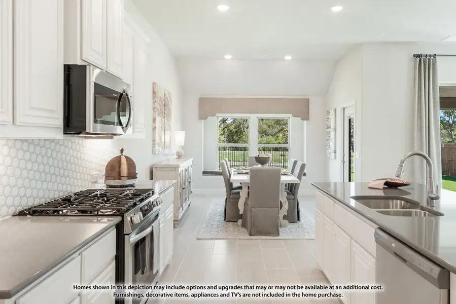 Kitchen with white cabinets, stainless steel appliances, hexagon tile backsplash, and open view to dining area with large windows. Kitchen with white cabinets, stainless steel appliances, hexagon tile backsplash, and open view to dining area with large windows.