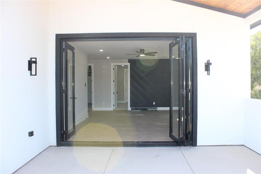 View of exterior entry featuring ceiling fan