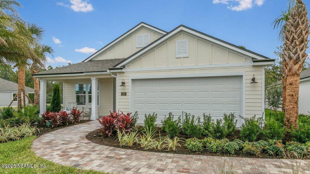 Front exterior of a new home in American Village, Palm Coast, FL, highlighting curb appeal (Image 19).