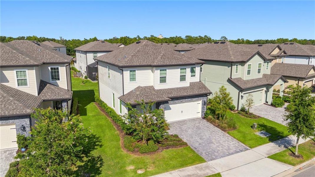 Front exterior of a new home in Reunion Village, Kissimmee, FL, highlighting curb appeal (Image 30).