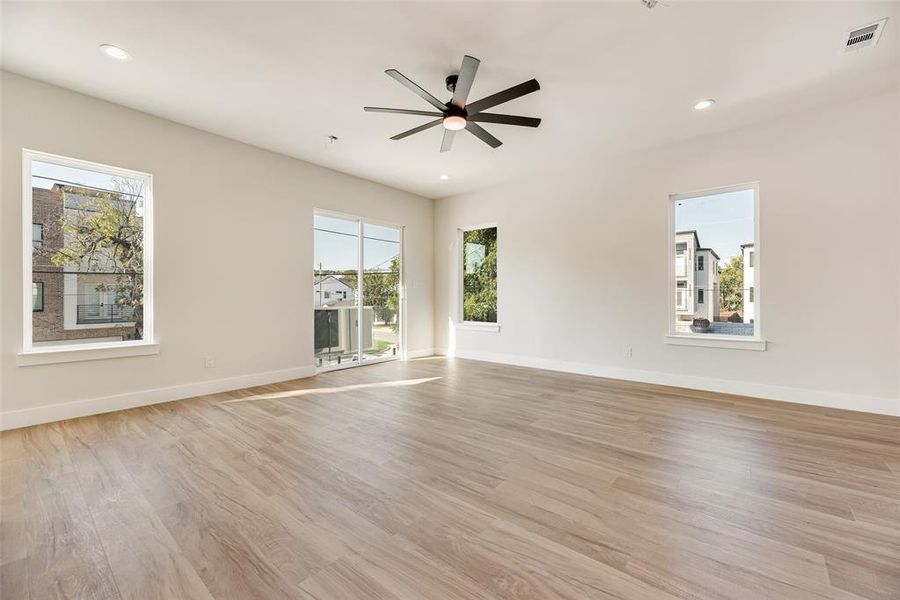 Spare room featuring recessed lighting, light wood-style floors, healthy amount of natural light, and a ceiling fan Spare room featuring recessed lighting, light wood-style floors, healthy amount of natural light, and a ceiling fan