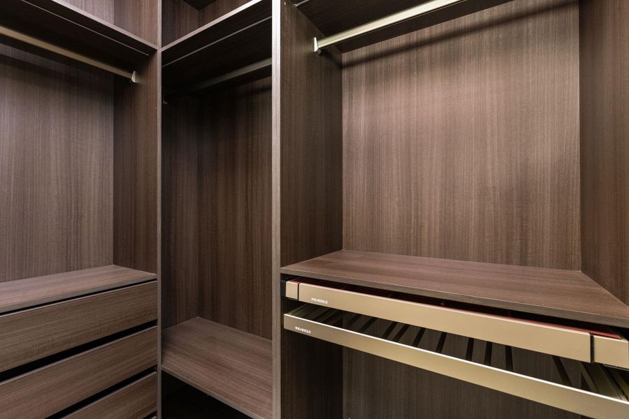 Ample storage solutions abound in this well-appointed walk-in closet, providing exceptional organization.