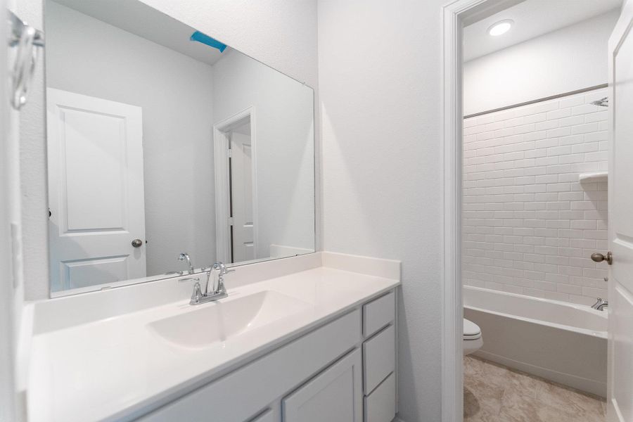 Full bath with vanity and shower / bath combination