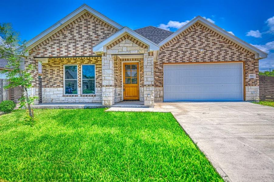 View of front of home featuring brick siding, an attached garage, a front lawn, and concrete driveway View of front of home featuring brick siding, an attached garage, a front lawn, and concrete driveway