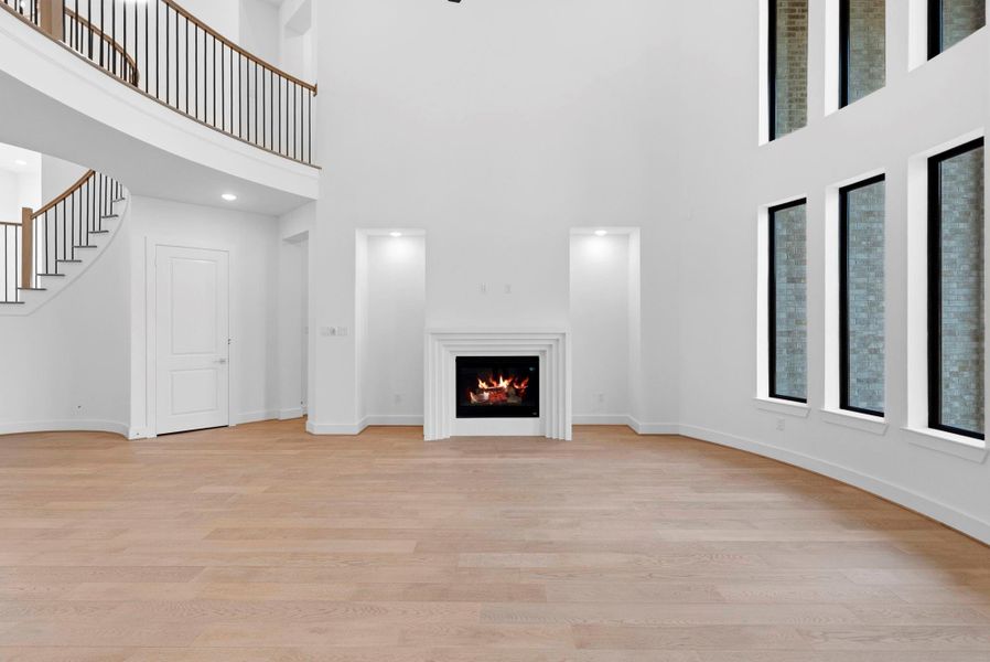Open family room with soaring ceilings and windows perfect for sunshine or moonlight.