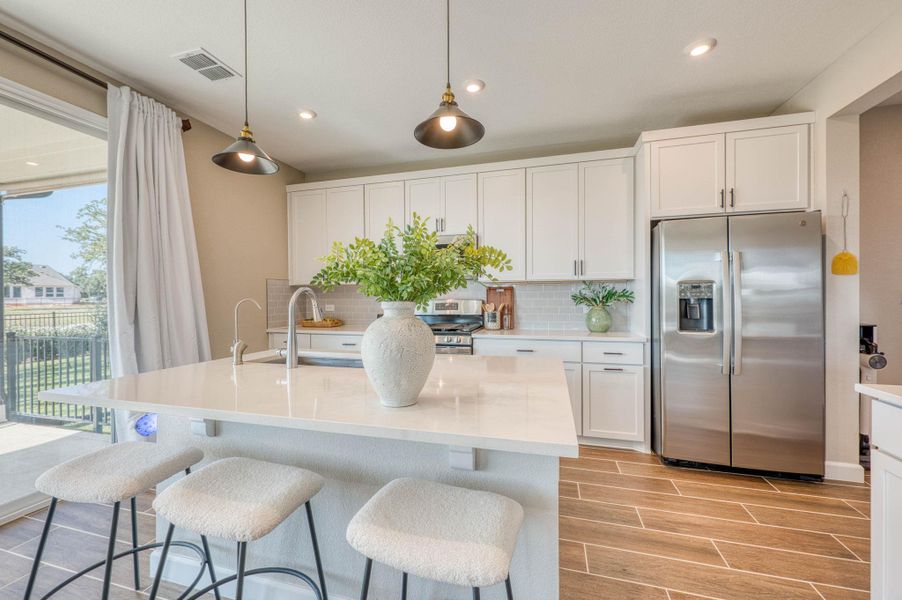 Streamlined cabinetry and premium appliances define this elegant culinary space with courtyard access. Streamlined cabinetry and premium appliances define this elegant culinary space with courtyard access.