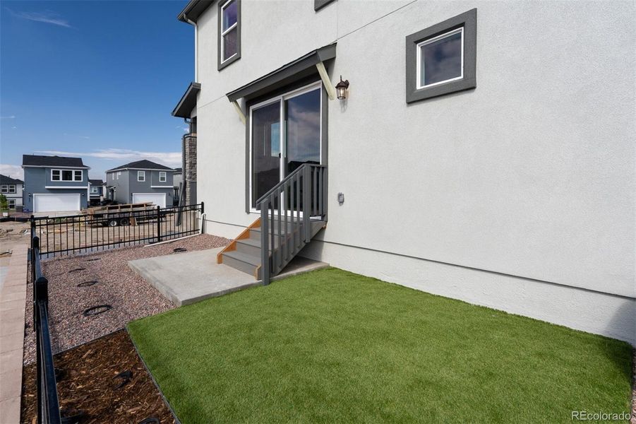 Front exterior of a new home in Revel Crossing at Wolf Ranch – The Ascent Collection, Colorado Springs, CO, highlighting curb appeal (Image 20).