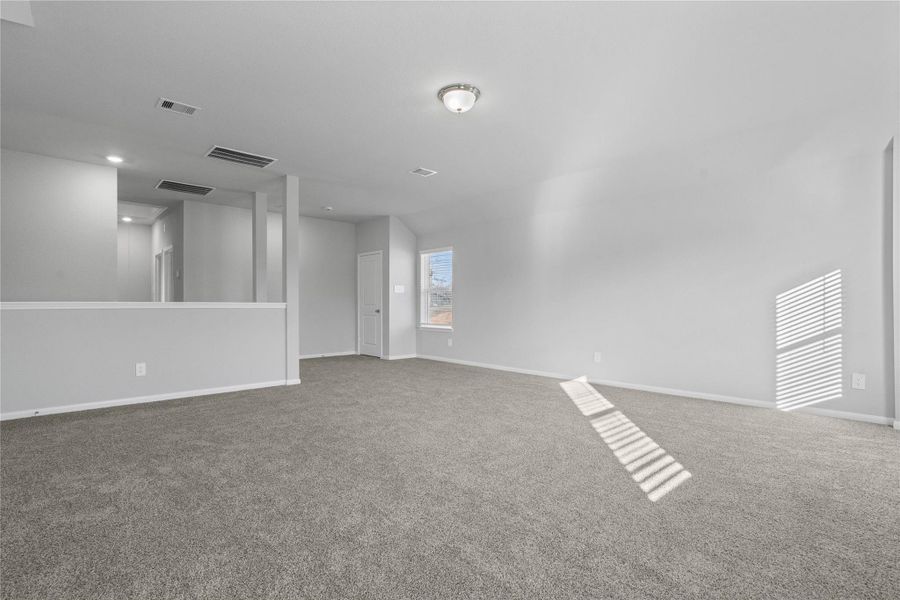 Additional view from Game Room to staircase and hallway leading to the secondary bedrooms and bathroom.