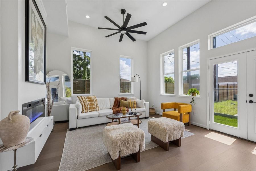 Light filled living room featuring soaring ceilings, expansive windows, and a seamless connection to the private outdoor space. Light filled living room featuring soaring ceilings, expansive windows, and a seamless connection to the private outdoor space.