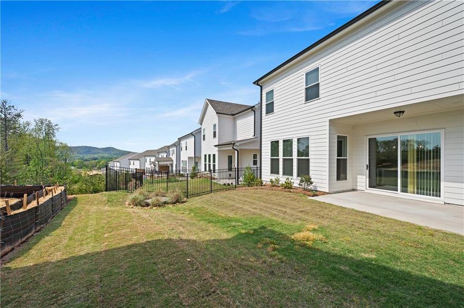 Exterior details and patio area of a home in Palisades Single Family, Cumming (Image 3).