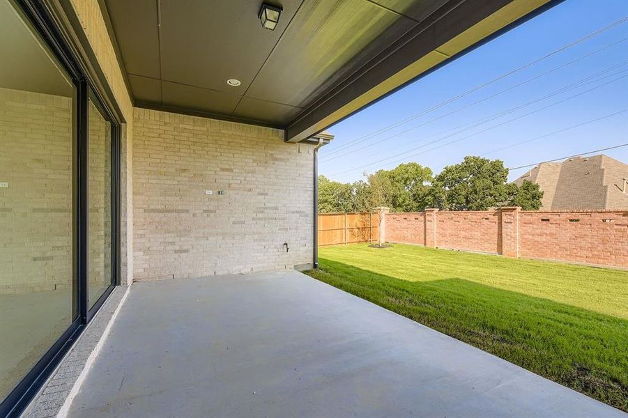 Fenced backyard featuring a patio area Fenced backyard featuring a patio area