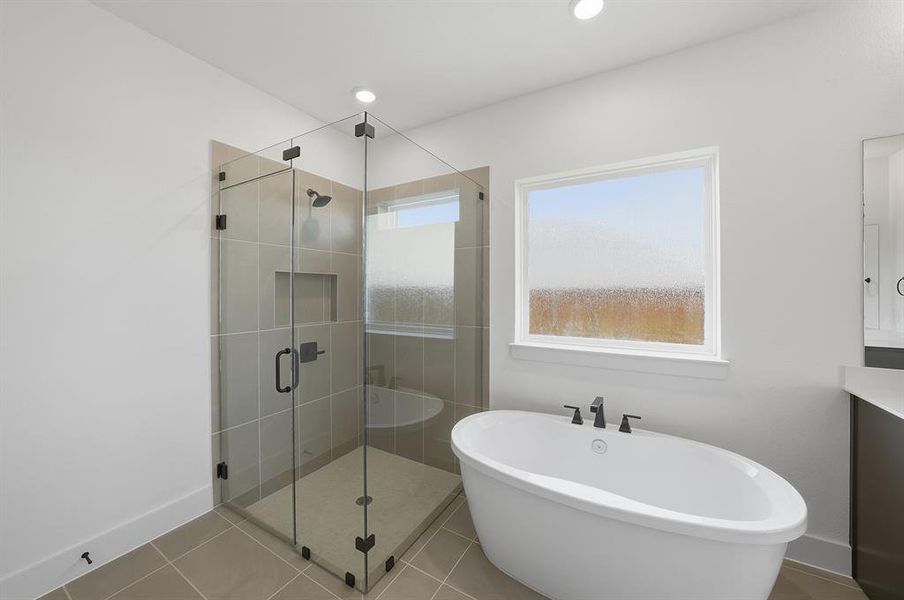 Full bathroom featuring tile patterned floors, a freestanding bath, vanity, a shower stall, and recessed lighting Full bathroom featuring tile patterned floors, a freestanding bath, vanity, a shower stall, and recessed lighting