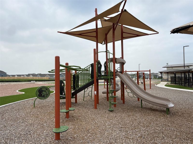 Playground structure featuring multiple slides and climbing elements