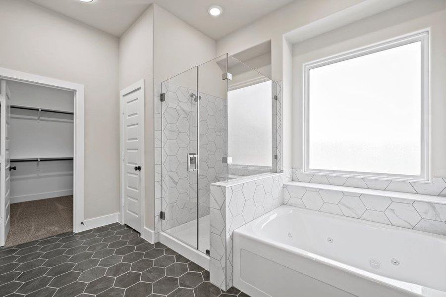 Full bath featuring a whirlpool tub, a stall shower, a walk in closet, tile patterned floors, and recessed lighting Full bath featuring a whirlpool tub, a stall shower, a walk in closet, tile patterned floors, and recessed lighting